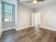 Bright bedroom featuring new dark wood floors, a ceiling fan, and a window at 2111 26Th S St, St Petersburg, FL 33712