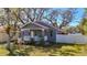 Lovely home with a cozy front porch framed by trees and landscaped yard at 2111 26Th S St, St Petersburg, FL 33712