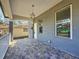 Inviting front porch with stone flooring and a charming overhead light fixture at 2111 26Th S St, St Petersburg, FL 33712