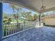 Front porch featuring stone floor, a hanging light fixture, white railing, and view of the neighborhood at 2111 26Th S St, St Petersburg, FL 33712