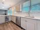 Bright kitchen showcases stainless steel appliances, wine fridge and modern cabinetry at 2111 26Th S St, St Petersburg, FL 33712