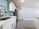 Bright kitchen with stainless steel appliances, white cabinetry, and a wood-look tile floor at 2111 26Th S St, St Petersburg, FL 33712