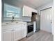 This kitchen features white cabinets, stainless appliances, and a window providing natural light at 2111 26Th S St, St Petersburg, FL 33712