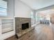 Inviting living room featuring a stone fireplace and built-in bookshelves, adjacent to the modern kitchen area at 2111 26Th S St, St Petersburg, FL 33712