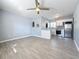 This living room has tiled floors, ceiling fan, and eat-in kitchen with stainless steel appliances at 2111 26Th S St, St Petersburg, FL 33712