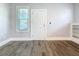 Bright living room with sleek flooring, window with blinds, and fresh white trim at 2111 26Th S St, St Petersburg, FL 33712