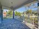 View from porch with stone floor and white railing overlooking the front yard at 2111 26Th S St, St Petersburg, FL 33712