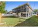 Exterior view showcasing the home's backyard and covered parking area, with additional screened porch at 227 84Th Ne Ave, St Petersburg, FL 33702