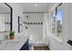 Beautiful bathroom featuring white tile, a shower, and a blue vanity with a marble countertop and stylish decor at 227 84Th Ne Ave, St Petersburg, FL 33702