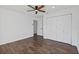 Bright bedroom featuring wood-look floors, a ceiling fan, and a double door closet with white doors at 227 84Th Ne Ave, St Petersburg, FL 33702