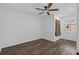 Clean bedroom with minimalist style, wood-look floors, a ceiling fan, and a bright window with natural light at 227 84Th Ne Ave, St Petersburg, FL 33702