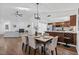 Open-concept dining room boasts wood floors, neutral paint and views of the kitchen at 227 84Th Ne Ave, St Petersburg, FL 33702