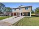 Stunning elevated home features a two-car drive, lush lawn, and modern neutral paint at 227 84Th Ne Ave, St Petersburg, FL 33702