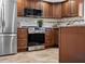 Lovely kitchen features stainless steel appliances, custom cabinets, and tile floors at 227 84Th Ne Ave, St Petersburg, FL 33702