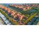 Overhead view of the waterfront community with a boat dock, lush trees, and ample parking at 2717 Via Cipriani # 614B, Clearwater, FL 33764