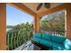 Balcony with comfortable seating offering serene views of lush greenery and water at 2717 Via Cipriani # 614B, Clearwater, FL 33764