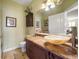 Bathroom with a unique vessel sink, dark wood vanity, and decorative wall art at 2717 Via Cipriani # 614B, Clearwater, FL 33764