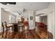 Open-concept dining area with bar seating, hardwood floors, and connections to the kitchen and living spaces at 2717 Via Cipriani # 614B, Clearwater, FL 33764