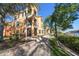 Elegant building exterior featuring balconies, lush landscaping, and a walkway leading to waterfront views at 2717 Via Cipriani # 614B, Clearwater, FL 33764