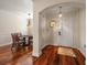 Inviting foyer with hardwood floors, arched doorway, and stylish lighting leading to dining area at 2717 Via Cipriani # 614B, Clearwater, FL 33764