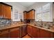 Kitchen featuring stainless steel appliances, granite counters, modern backsplash, and ample cabinet space at 2717 Via Cipriani # 614B, Clearwater, FL 33764