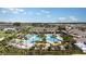 Aerial view of community pool, clubhouse, and surrounding homes at 31726 Griffin Sands Ln, San Antonio, FL 33576