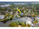 Aerial view of a waterfront home featuring a private dock and boat lift with canal access at 320 Georgia Ave, Crystal Beach, FL 34681