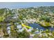 Aerial view of waterfront home with mature trees, private dock, and canal access to open water at 320 Georgia Ave, Crystal Beach, FL 34681