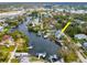 Aerial view of home on a canal with mature trees, a private dock, and easy street access at 320 Georgia Ave, Crystal Beach, FL 34681