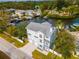 Aerial view of a two-story waterfront home with lush landscaping and private boat dock access at 320 Georgia Ave, Crystal Beach, FL 34681