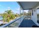 Tranquil balcony view showing waterfront canal, boats, and serene neighborhood with lush trees at 320 Georgia Ave, Crystal Beach, FL 34681