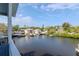 Scenic balcony view showing the serene waterway and neighboring homes with boat docks at 320 Georgia Ave, Crystal Beach, FL 34681