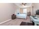 A tidy bedroom with a light-colored carpet, a matching computer desk, and two windows for great natural light at 320 Georgia Ave, Crystal Beach, FL 34681