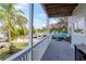 Serene outdoor deck with seating, grill and water view, a perfect extension of indoor living at 320 Georgia Ave, Crystal Beach, FL 34681