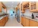 Spacious kitchen featuring granite countertops, stainless steel appliances, and a wine rack at 320 Georgia Ave, Crystal Beach, FL 34681