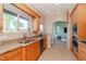 Charming kitchen featuring granite countertops, stainless steel appliances, and a bright sunny window at 320 Georgia Ave, Crystal Beach, FL 34681