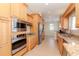 Well-lit kitchen featuring granite countertops, stainless steel appliances, and custom wood cabinetry at 320 Georgia Ave, Crystal Beach, FL 34681