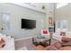 Bright living room with high ceilings, fireplace, large TV, and comfortable white and brown sofas at 320 Georgia Ave, Crystal Beach, FL 34681