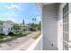 Charming neighborhood street view from the balcony, showcasing nearby homes and lush landscaping at 320 Georgia Ave, Crystal Beach, FL 34681