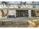 Exterior backyard view showcasing a large screened patio and well-maintained outdoor space at 3313 Pleasant Willow Ct, Brandon, FL 33511