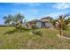 Well-maintained backyard featuring lush grass, a picnic table, and tasteful landscaping with lovely palms at 37157 Foxrun Pl, Zephyrhills, FL 33542