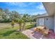 Backyard patio area featuring picnic table and landscaping at 37157 Foxrun Pl, Zephyrhills, FL 33542