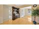 Dining room featuring wood floors, hutch and entry to office and bath at 37157 Foxrun Pl, Zephyrhills, FL 33542