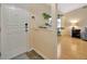 Inviting foyer with tile flooring and a view into a living space with wood floors at 37157 Foxrun Pl, Zephyrhills, FL 33542