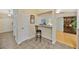 Kitchen view featuring bar stool, white cabinets and views into the living room at 37157 Foxrun Pl, Zephyrhills, FL 33542