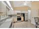 Modern kitchen featuring stainless steel appliances, tile backsplash, and ample counter space at 37157 Foxrun Pl, Zephyrhills, FL 33542