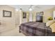 Comfortable main bedroom featuring carpet flooring, a ceiling fan, and neutral paint at 37157 Foxrun Pl, Zephyrhills, FL 33542