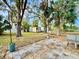 Large backyard featuring a shed, patio, mature trees and lush greenery at 3902 W Iowa Ave, Tampa, FL 33616