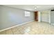 Bright bedroom featuring tiled flooring, closet, and a window providing ample natural light at 3902 W Iowa Ave, Tampa, FL 33616