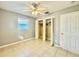 Bright bedroom featuring a ceiling fan, window, neutral paint, and a closet at 3902 W Iowa Ave, Tampa, FL 33616